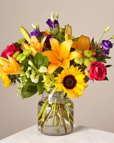 Make this day their best day. Our local florist handcraft a colorful array of flowers in a clear glass vase to create a celebration in bloom. Perfect to give for a special reason or to simply share a smile.
<ul>
<li>Our florists hand-design each arrangement, so colors, varieties and container may vary due to local availability</li>
</ul>