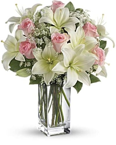 <div id="mark-3" class="m-pdp-tabs-marketing-description">Stunning in its simplicity, this innocent harmony of light pink roses and snow white lilies are a heartfelt way to send your very best. The classic, clear rectangular glass vase keeps the focus on the heavenly beauty of the blooms.</div>
<div id="desc-3">
<ul>
<li>Light pink roses and white asiatic lilies form a fragrant bouquet with delicate touches of Queen Anne's lace and rich green salal.</li>
<li>Our florists hand-design each arrangement, so colors, varieties and containers may vary due to local availability</li>
</ul>
</div>