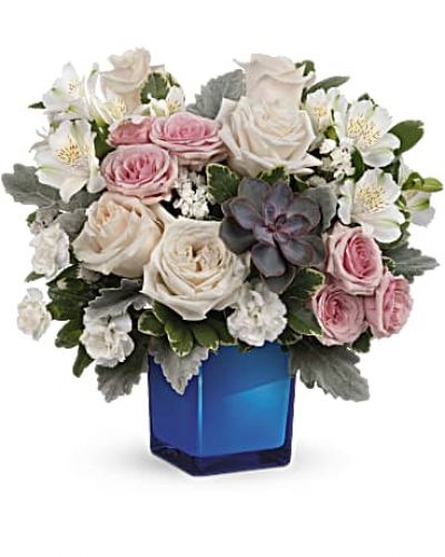 <div id="mark-3" class="m-pdp-tabs-marketing-description">Soft as a whisper, this enchanting bouquet of cream and pink roses looks oh-so-lovely in a colored or clear glass cube that later becomes a comely candleholder.</div>
<div id="desc-3">Crème roses, pink spray roses, white alstroemeria and miniature white carnations are arranged with variegated pittosporum, dusy miller, white sinuata statice and a large, potted green echeveria succulent.
<ul>
<li>Our florists hand-design each arrangement, so colors, varieties and containers may vary due to local availability</li>
</ul>
</div>